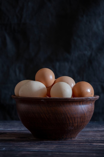 Chicken eggs in a clay plate on the table