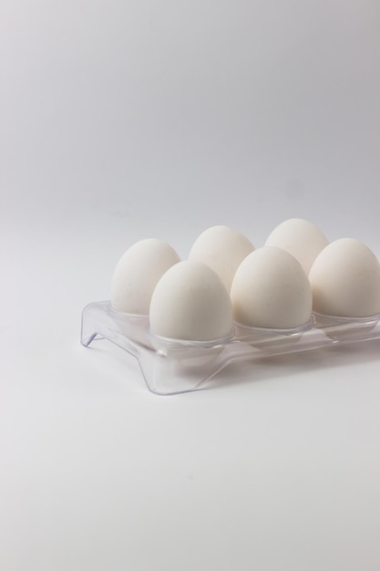 Chicken eggs in a tray on a white background Ingredients for cooking