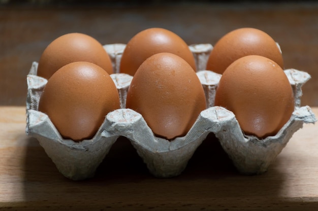 Chicken eggs on a wooden tray