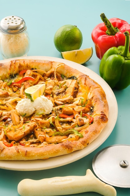 Chicken Fajita Pizza isolated on wooden background spiced chicken cubes and cheese combination on bread Italian food top view