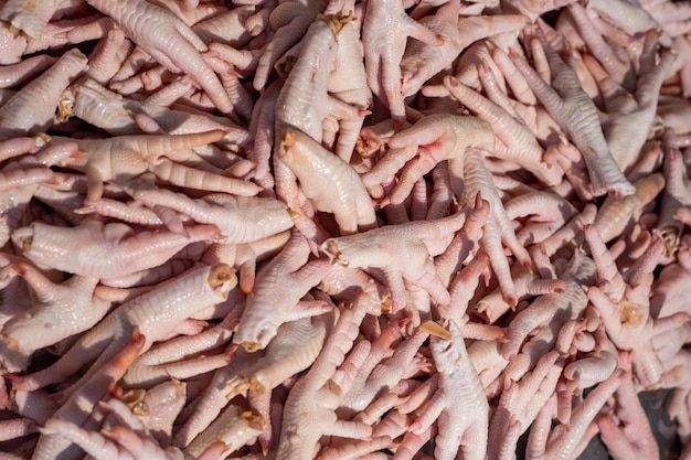 Chicken feet in a tray on the counter in the store Natural gelatin traditional Chinese cuisine