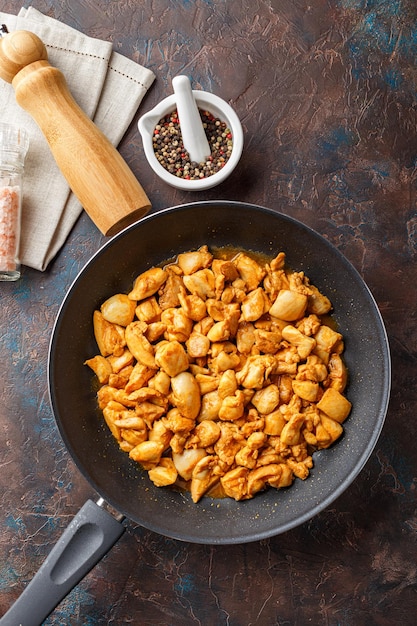 Chicken fillet cut into small pieces for frying in pan