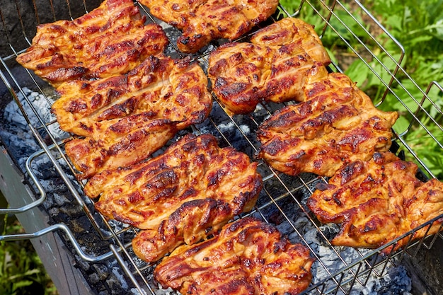 Chicken fillet fried on a grill on a metal grill