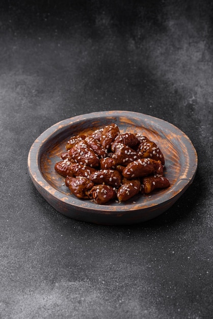 Chicken hearts fried in soy sauce with salt and spices in a plate