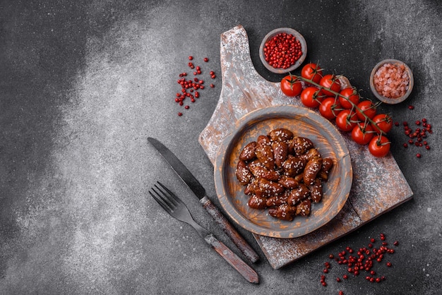 Chicken hearts fried in soy sauce with salt and spices in a plate