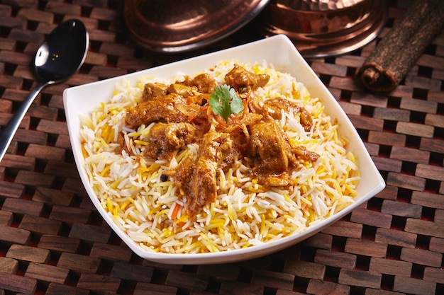 Chicken Lamb and mutton Biryani served in dish isolated on table side view of middle east food