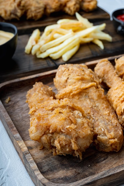 Chicken leg breaded and fried on white background.