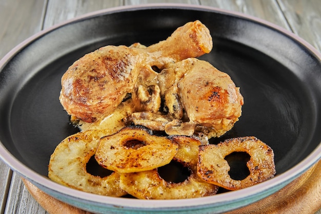 Chicken legs baked with mushrooms and apple mugs in the oven Chicken in cider