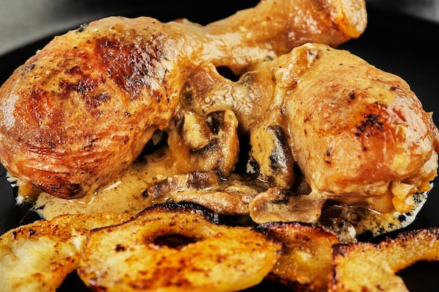 Chicken legs baked with mushrooms and apple mugs in the oven Chicken in cider