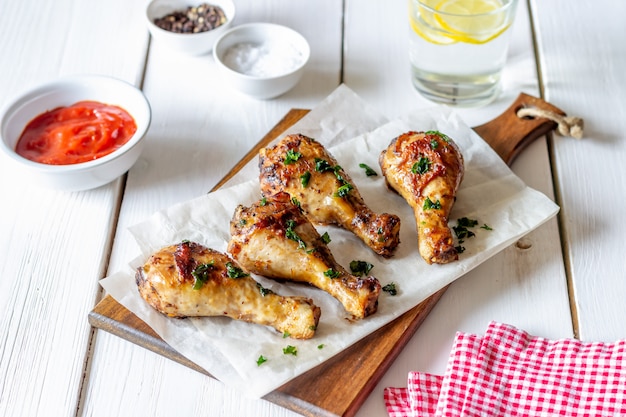 Chicken legs on a wooden table. Barbecue. Grill. American cuisine. Recipe. Rustic.