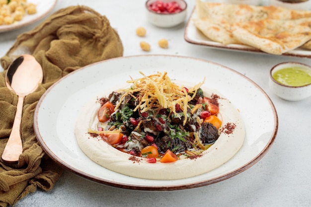 Chicken liver with Hummus served in dish isolated on table top view of arabian food