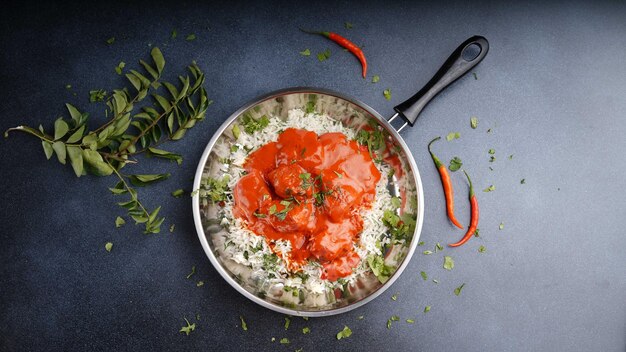 Chicken marinated in tandoori sauce serve with rice served in dish isolated on table top view of arabic food