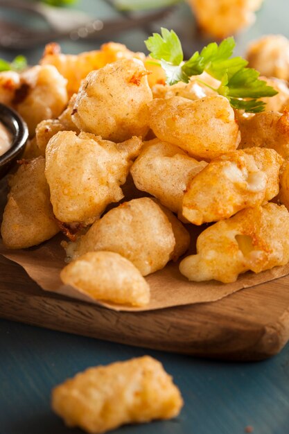 Chicken nuggets with french fries on wooden table