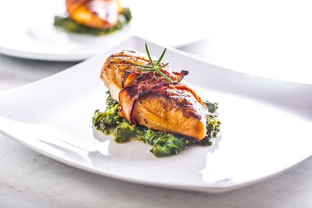 Chicken roasted breast with bacon and spinach on white plate Culinary food  in hotel  or restaurant