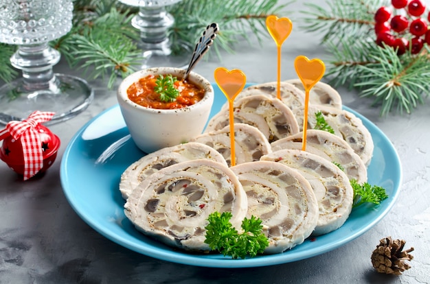 Chicken roll (roulade) with omelet (omelette) and mushrooms. New year's appetizer