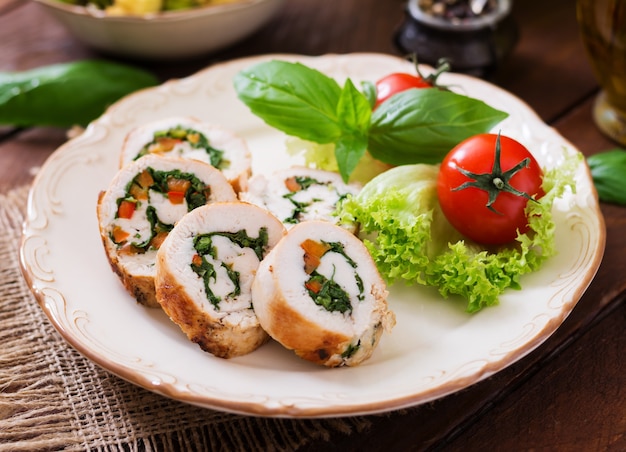 Photo chicken rolls with greens, garnished with salad.