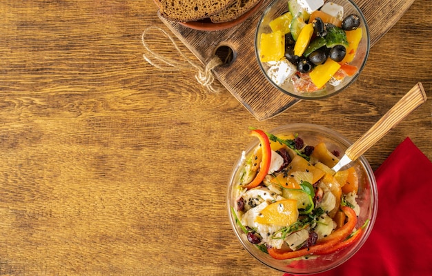 Chicken salad and Greek salad with olives feta cheese tomatoes
sweet pepperTop view banner