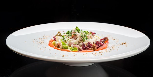 Chicken salad, Salad with meat and tomato on a plate