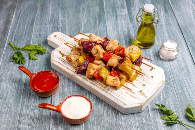 Chicken shish kebab with vegetables,ketchup,mayonnaise,top view