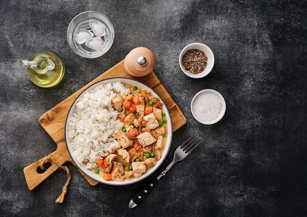 Chicken stew with vegetables and mushroom cream sauce Tender chicken fillet in a creamy mushroom sauce with rice and green peas