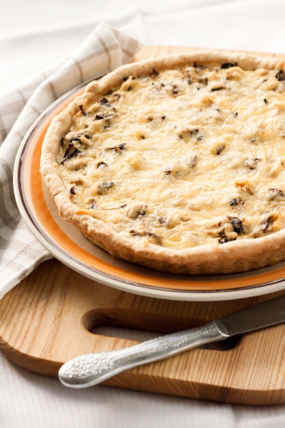 Chicken tart with mushrooms and cheese on a plate