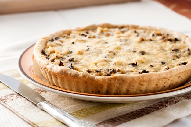 Chicken tart with mushrooms and cheese on a plate