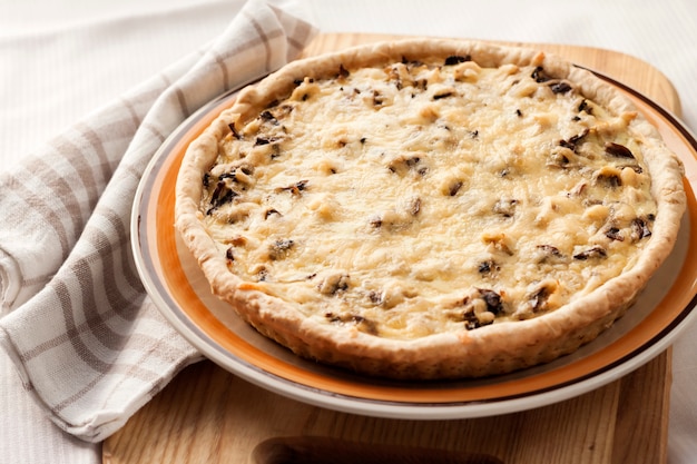 Chicken tart with mushrooms and cheese on a plate