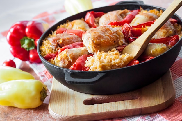 Chicken thighs and legs baked over a bed of rice and red bell pepper