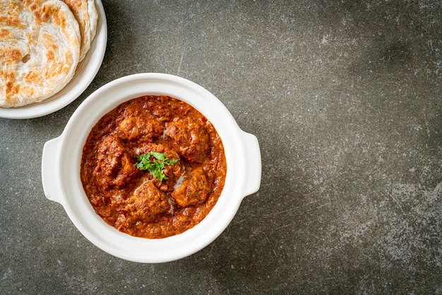 Chicken tikka masala spicy curry meat food with roti or naan bread