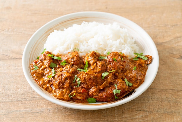 Chicken tikka masala with rice on plate