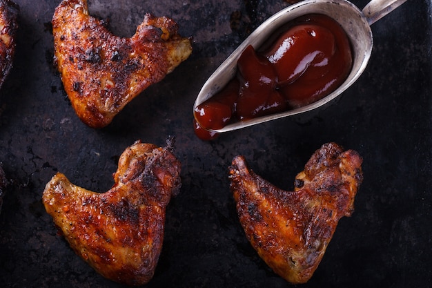 Chicken wings fried on the grill with BBQ sauce 