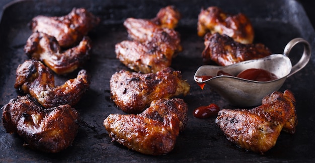 Chicken wings fried on the grill with BBQ sauce