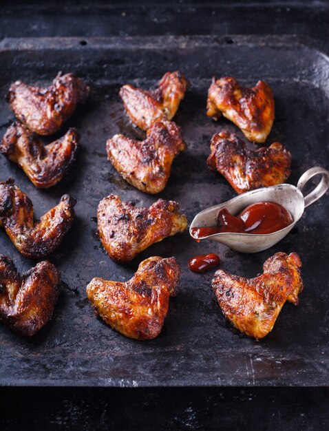 Chicken wings fried on the grill with BBQ sauce 