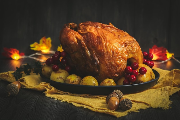 Chicken with potatoes in a dish on a yellow kitchen napkin garland leaves and acorns