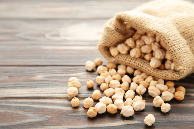 Chickpea in bag on brown wooden table