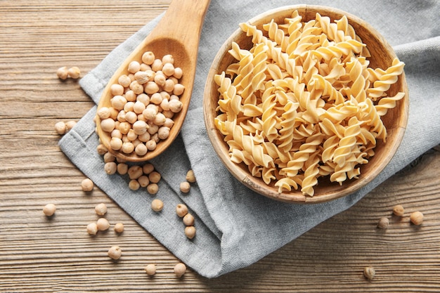 Chickpea bean fusilli pasta on a old wooden background