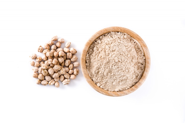 chickpea flour in wooden bowl isolated on white, top view