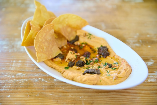 chickpea hummus plate on wooden table