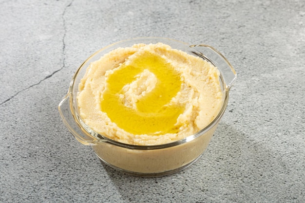 Chickpeas hummus with olive oil in the bowl