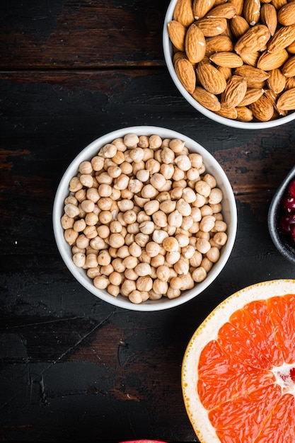 Chickpeas in white bowl on dark wooden background