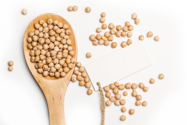 Chickpeas on a wooden spoon isolated on a white background