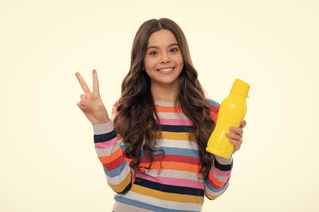 Child 12 13 14 years old with water bottle isolated studio background Water bottle and healthy life Health and water balance Happy girl face positive and smiling emotions