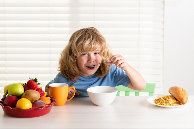 Child boy eating organic healthy food healthy vegetables with vitamins proper kids nutrition concept