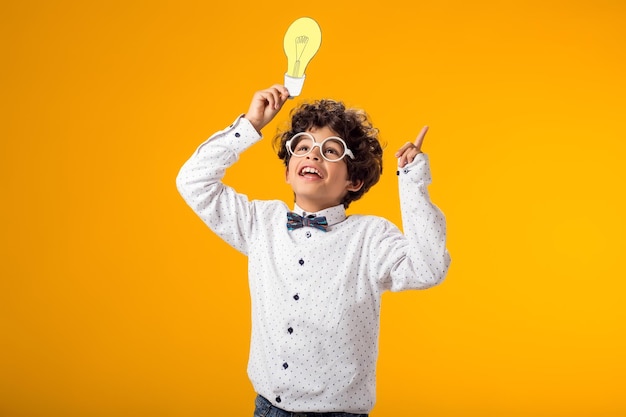 Child boy holding paper bulb Success motivation winner genius idea concept