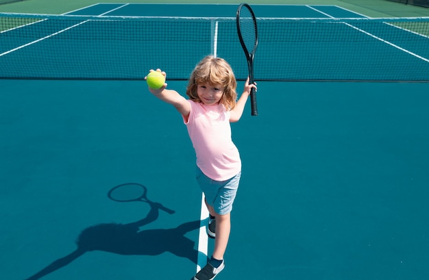 Photo child boy playing tennis on outdoor court little girl with tennis racket and ball in sport club