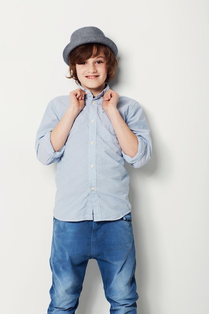 Photo child boy and portrait for fashion in studio cool clothing and confidence by white background happy male person kid and cute hat by backdrop or pride for style face and trendy outfit or relaxing