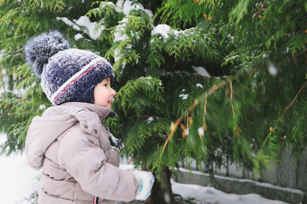 Child boy and snow. Winter time.