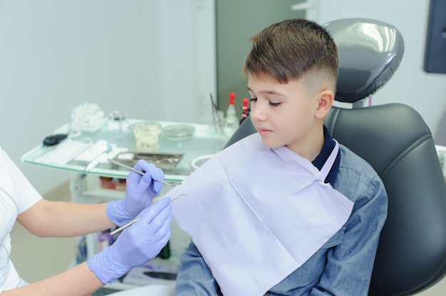 A child boy with a dentist in a dental office