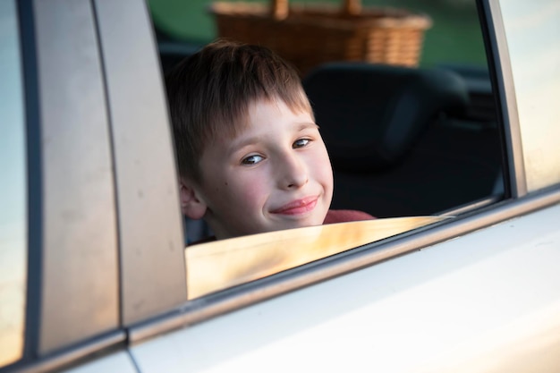 Child in the car A little boy looks out of the car window