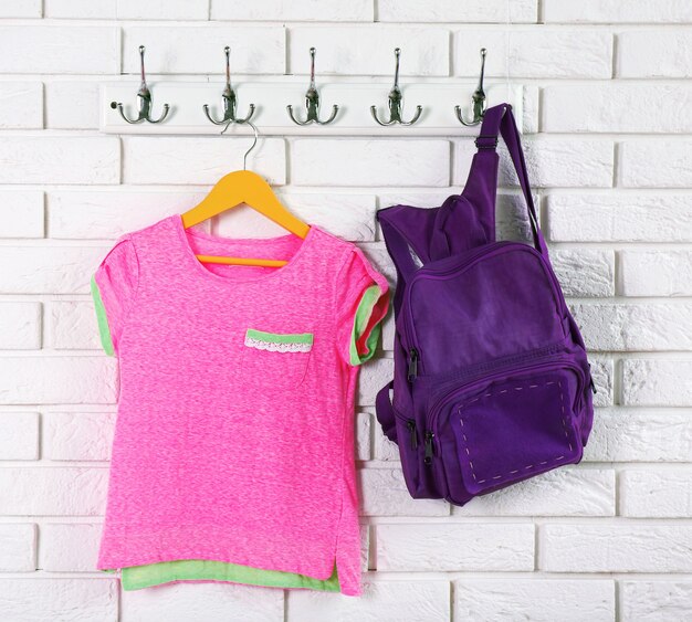 Photo child clothes on hanger on white wall background